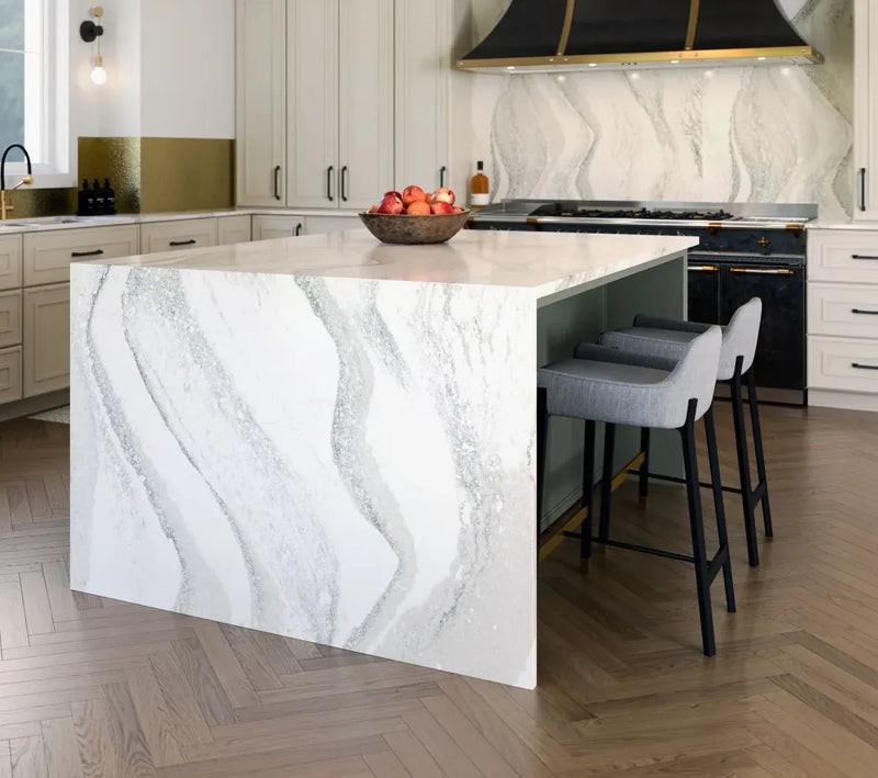 Cambria quartz kitchen island with dramatic black and gold veining and waterfall edges — luxury quartz countertops installed by Signature Stone Las Vegas