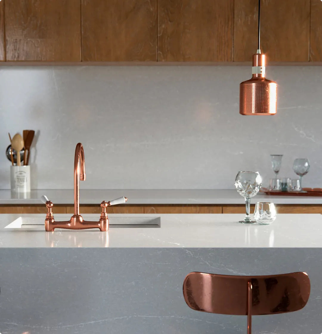 Silestone kitchen island with white quartz surface and copper fixtures — premium quartz countertops installed by Signature Stone Las Vegas