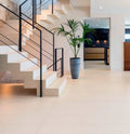 Dekton flooring with light beige finish and sleek modern staircase design — like dekton countertops installed by Signature Stone Las Vegas
