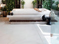 Silestone quartz flooring in modern bathroom with white finish and matching bathtub surround — quartz countertops installed by Signature Stone Las Vegas