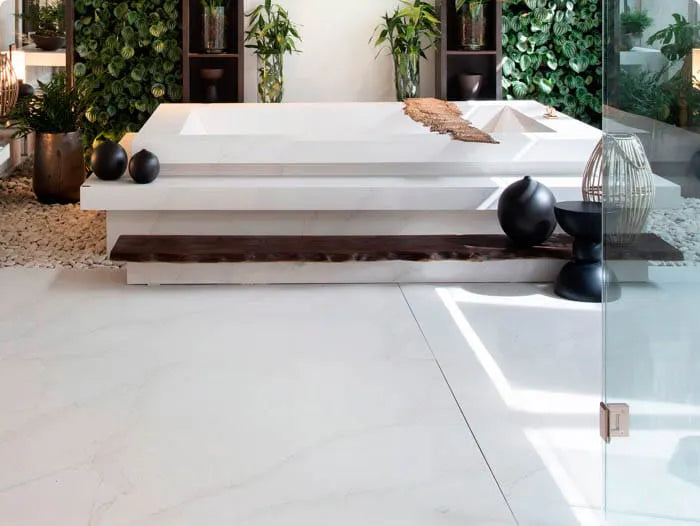 Silestone quartz flooring in modern bathroom with white finish and matching bathtub surround — quartz countertops installed by Signature Stone Las Vegas