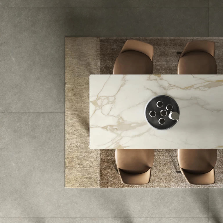 Calacatta Gold marble dining table with white base and gold veining in modern setting — premium countertop fabrication by Signature Stone Las Vegas