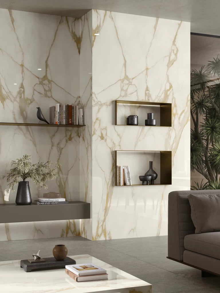 Calacatta Gold marble wall feature with golden veining and built-in shelving — custom countertops fabricated and installed by Signature Stone LV