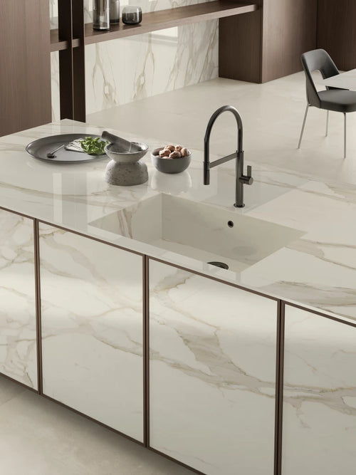 Calacatta Bernini quartz kitchen island with white marble veining and polished finish — custom countertops fabricated and installed by Signature Stone LV