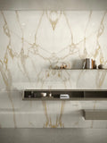 Calacatta Gold marble wall cladding with dramatic white and gold veining in modern bathroom — luxury stone countertops installed by Signature Stone Las Vegas
