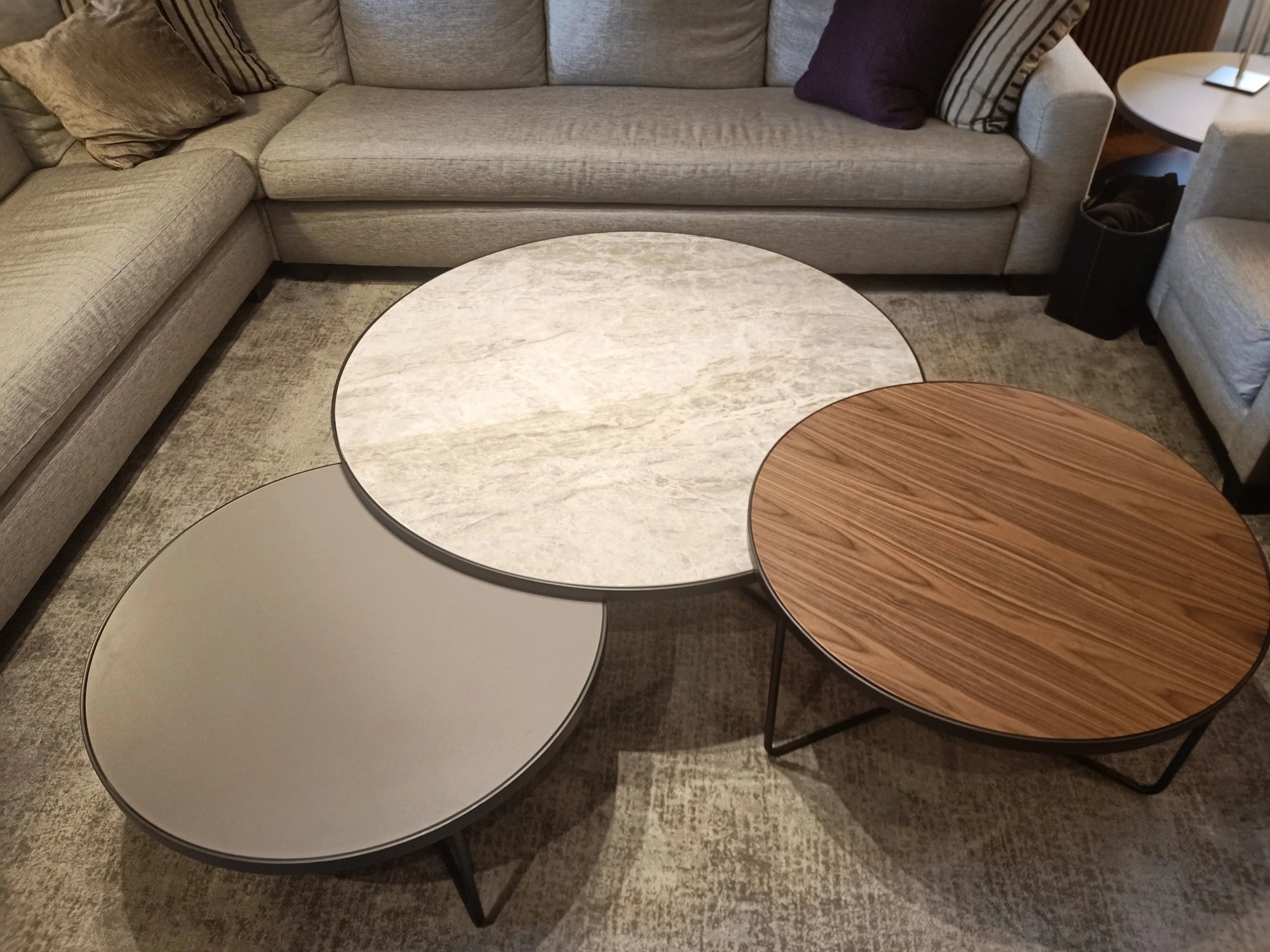 Dekton Arga coffee table with matte white marble-look finish and metal legs — premium dekton surfaces fabricated and installed by Signature Stone LV