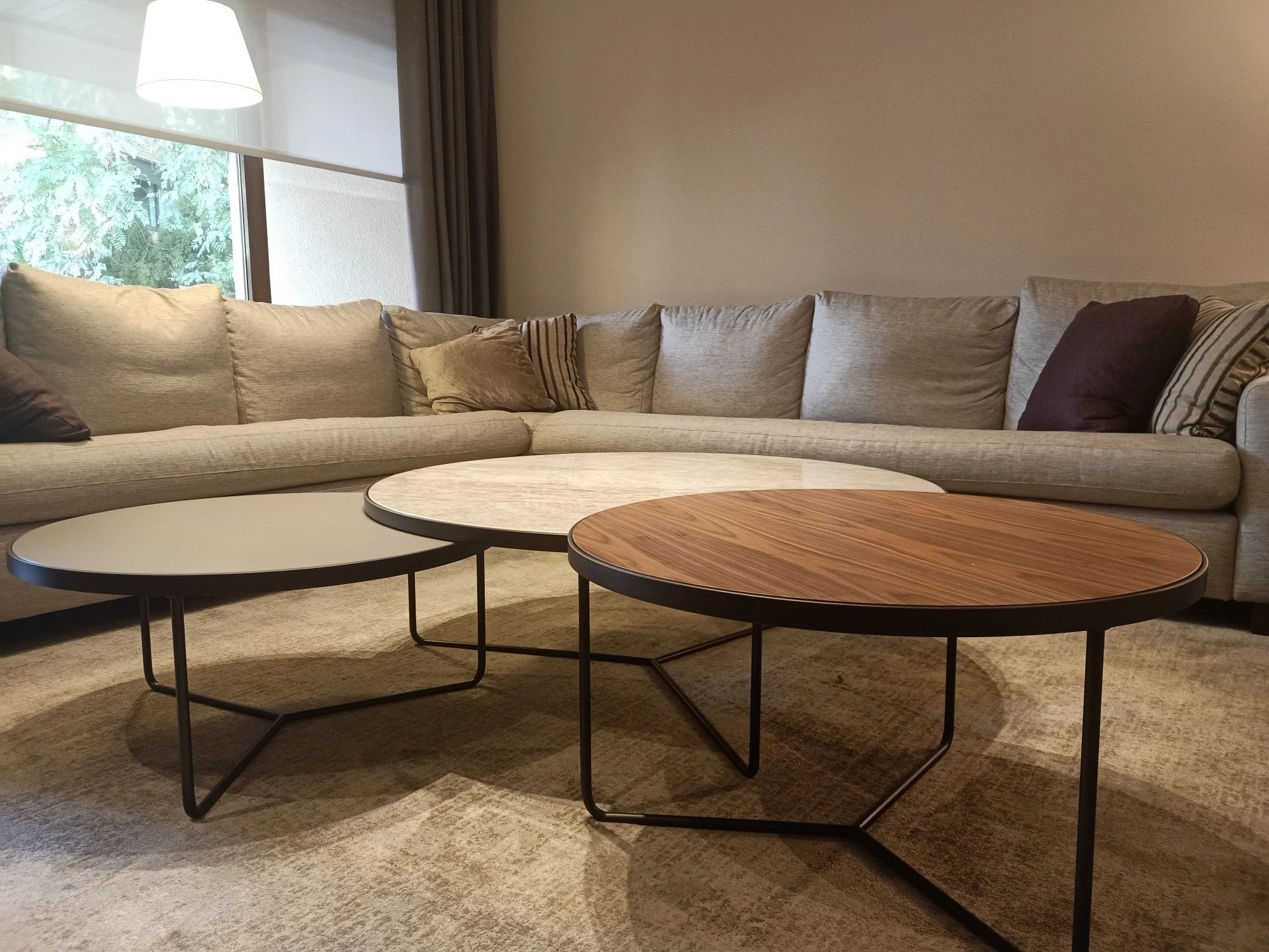 Dekton Arga coffee table tops with warm wood grain finish and sleek metal legs — dekton countertops installed by Signature Stone Las Vegas