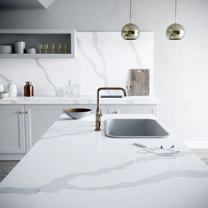 Silestone Bianco Calacatta kitchen island with white marble-look veining and polished finish — engineered quartz countertops fabricated and installed by Sign...