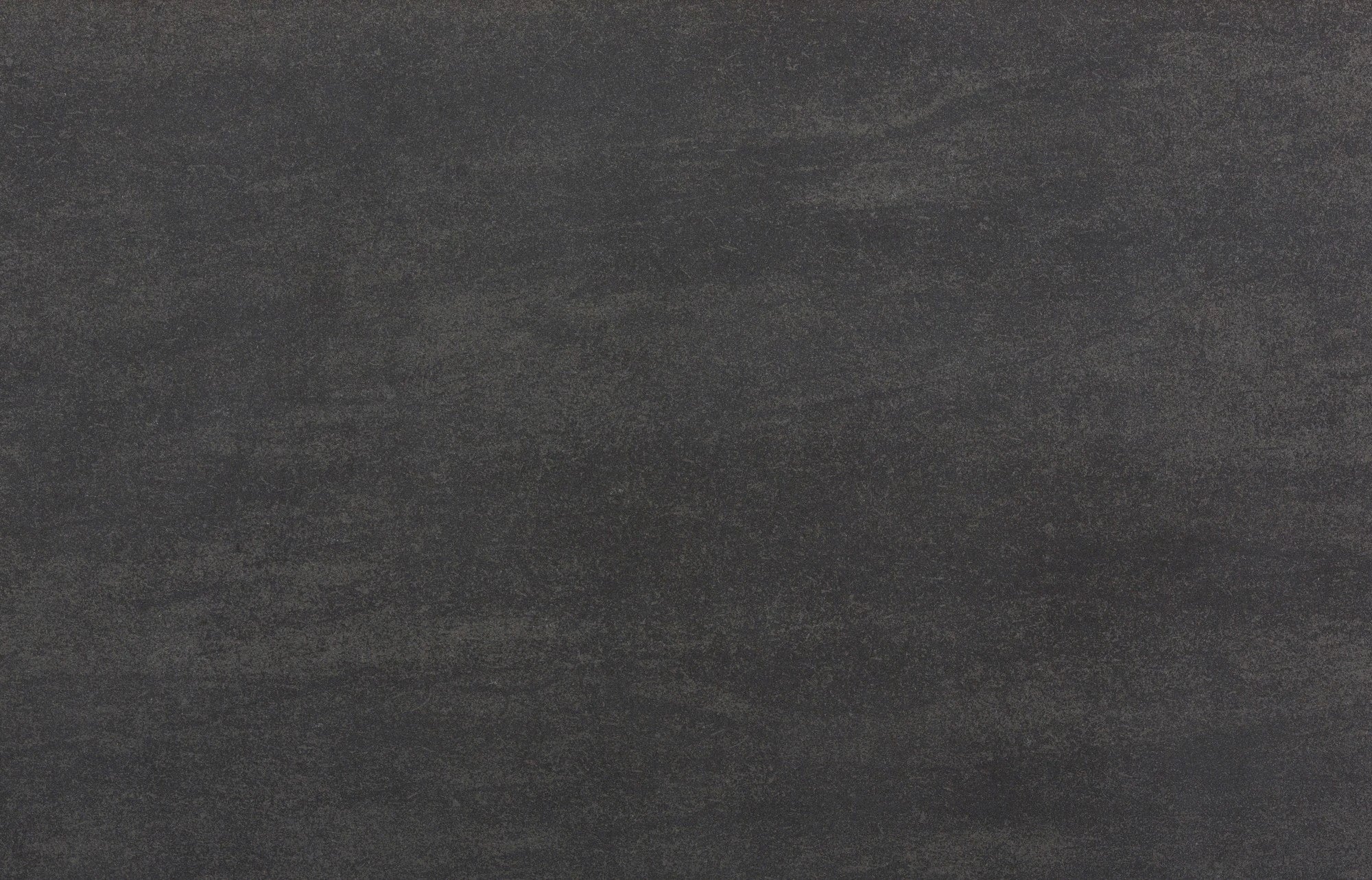 Dekton Bromo countertop surface with dark charcoal gray color and subtle linear veining — premium dekton surfaces fabricated and installed by Signature Stone LV