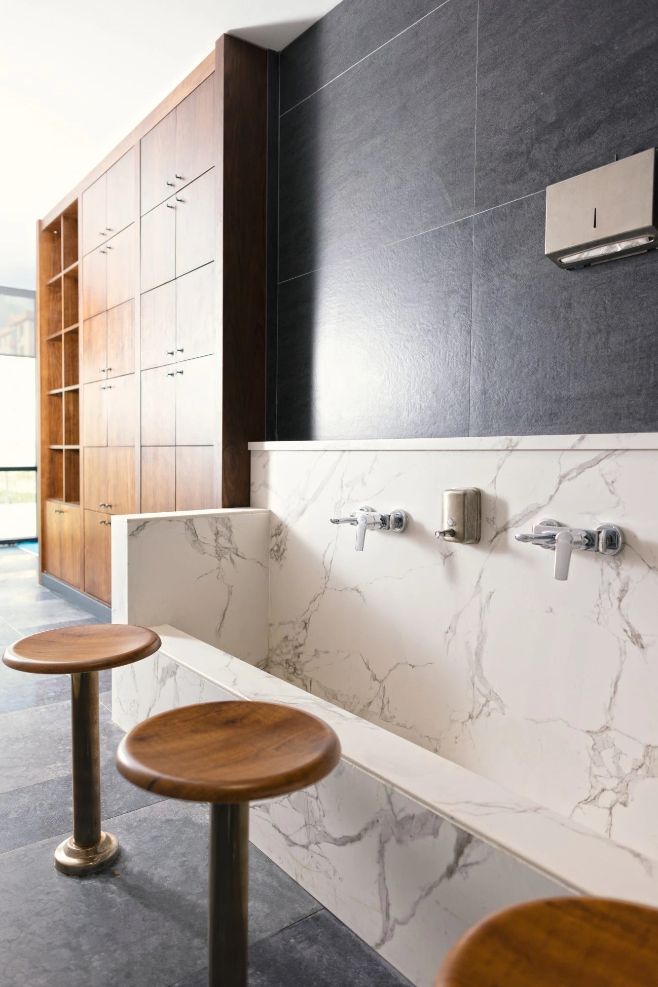 Dekton Bromo bathroom vanity with white marble-look finish and integrated sink — premium dekton surfaces fabricated and installed by Signature Stone LV