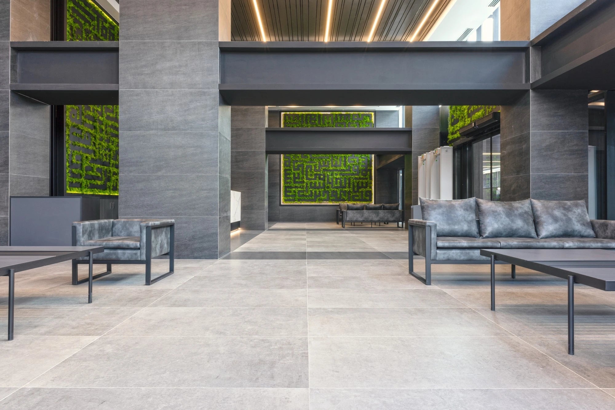 Dekton Bromo flooring with matte gray finish in modern commercial lobby — premium dekton surfaces fabricated and installed by Signature Stone LV