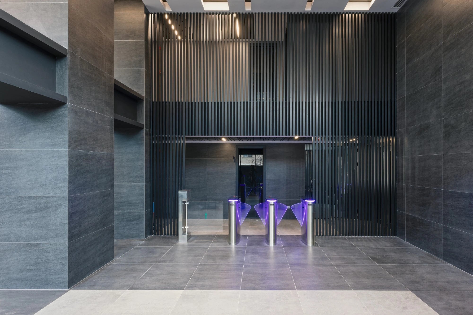 Dekton Bromo surfaces with dark gray finish in modern commercial lobby — premium dekton kitchen countertops by Signature Stone Las Vegas