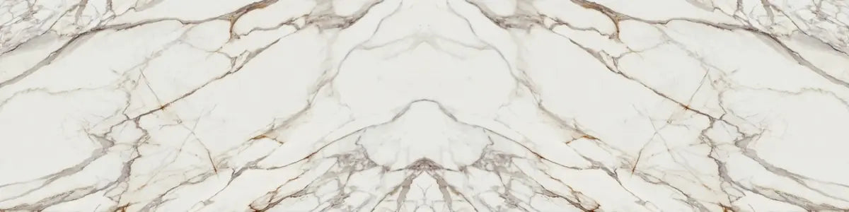 Calacatta Dorato marble slab with dramatic white base and golden brown veining — luxury stone countertops installed by Signature Stone Las Vegas