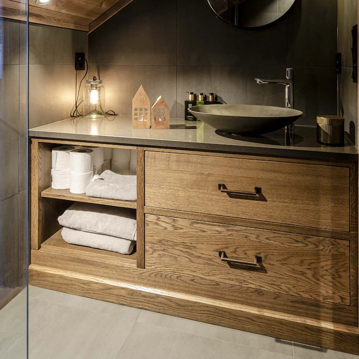 Silestone Calypso bathroom vanity with dark gray surface and natural wood cabinetry — engineered quartz countertops fabricated and installed by Signature Sto...