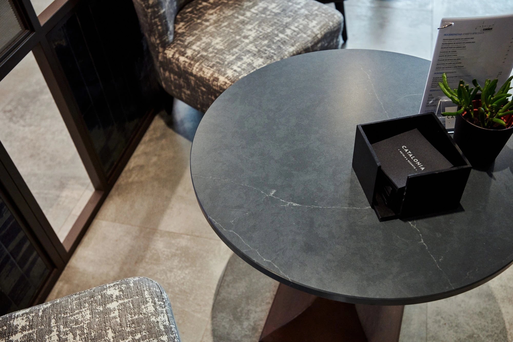 Silestone Charcoal Soapstone round table surface with dark gray veined finish — engineered quartz countertops fabricated and installed by Signature Stone LV