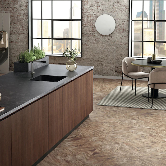 Silestone Corktown kitchen island with dark gray surface and warm wood grain base — engineered quartz countertops fabricated and installed by Signature Stone LV