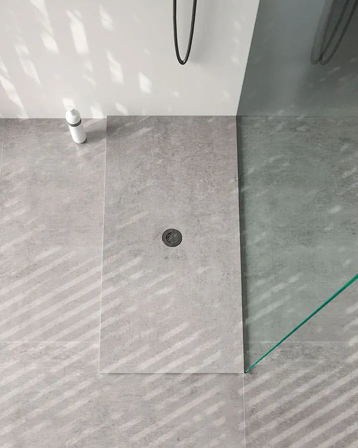 Dekton shower tray with gray textured surface and circular drain — dekton countertops installed by Signature Stone Las Vegas