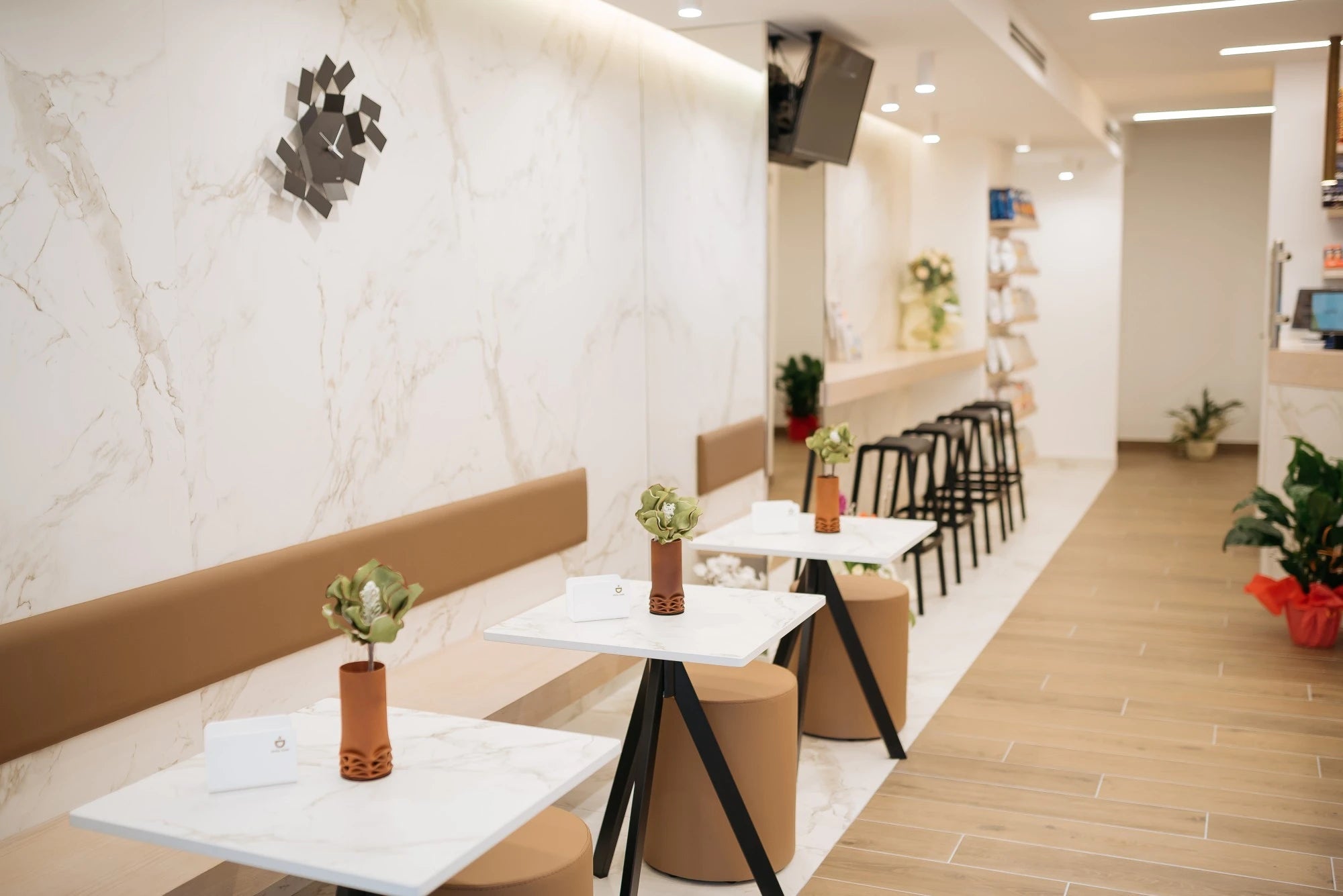 Dekton Entzo restaurant tables with white marble-look finish and black metal bases — dekton countertops installed by Signature Stone Las Vegas