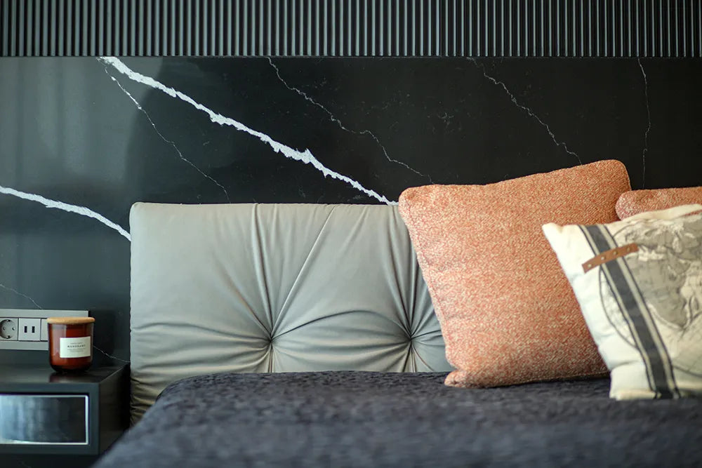 Silestone Et Marquina bedroom accent wall with dramatic black marble veining and white striations — engineered quartz countertops fabricated and installed by...