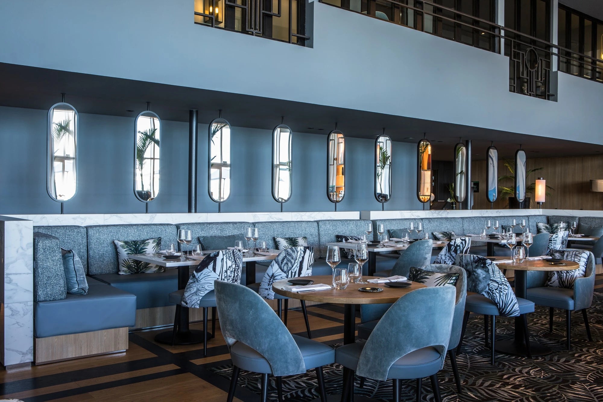 Silestone Et Statuario restaurant dining surfaces with white marble-look veining and polished finish — engineered quartz countertops fabricated and installed...