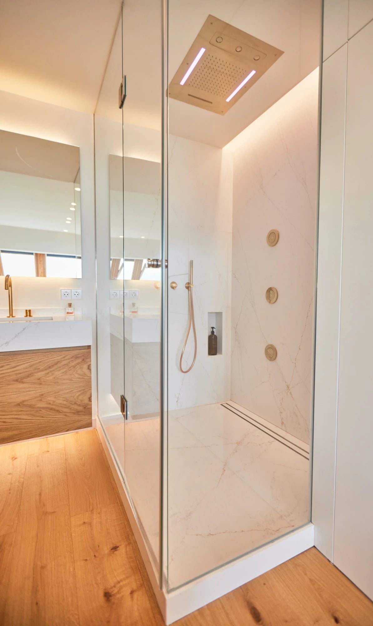 Silestone Ethereal Glow quartz shower walls with white veining and gold fixtures — premium quartz countertops near me by Signature Stone Las Vegas