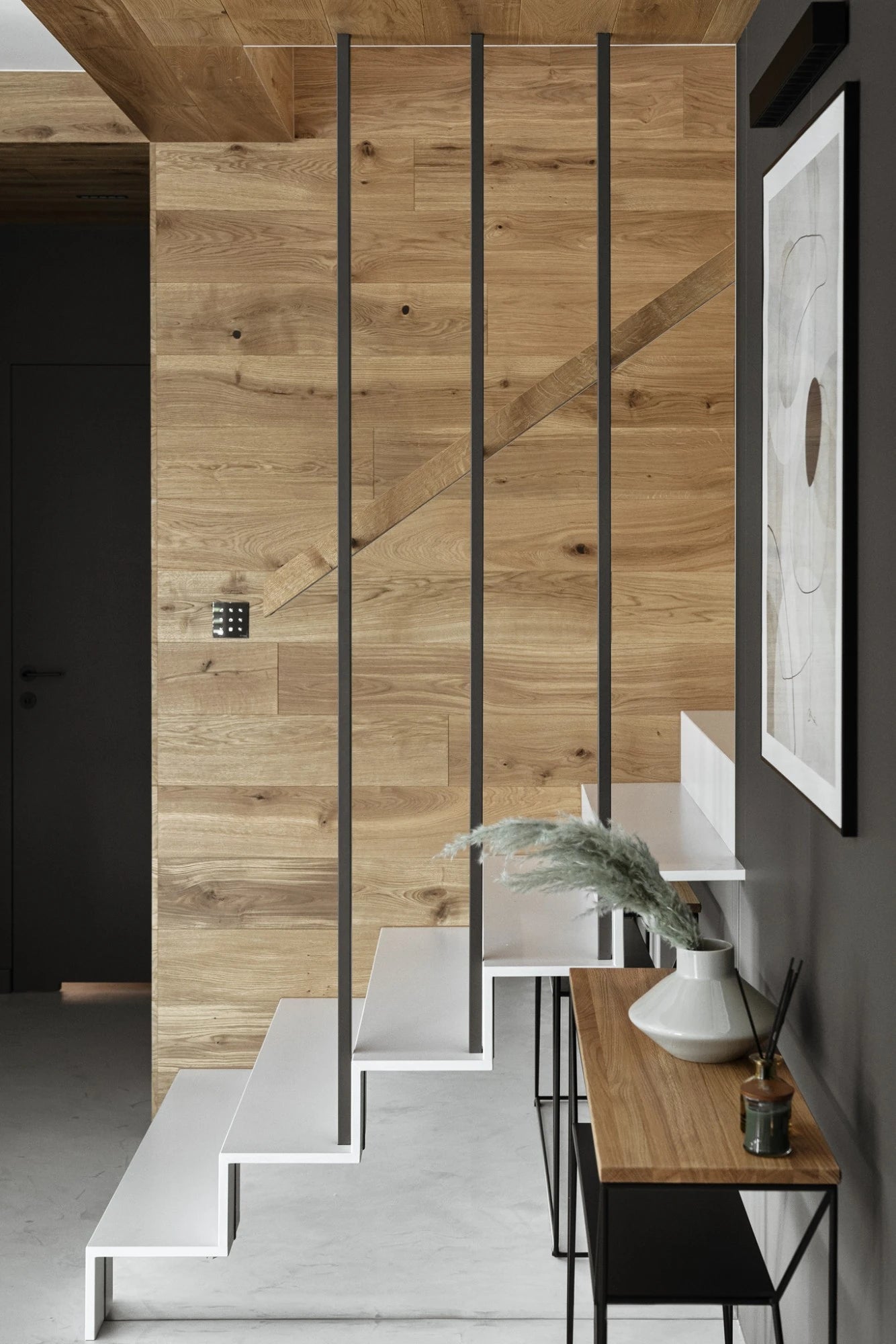 Silestone Ethereal Noctis quartz staircase with white steps and black metal railings in modern home — quartz countertops near me by Signature Stone Las Vegas