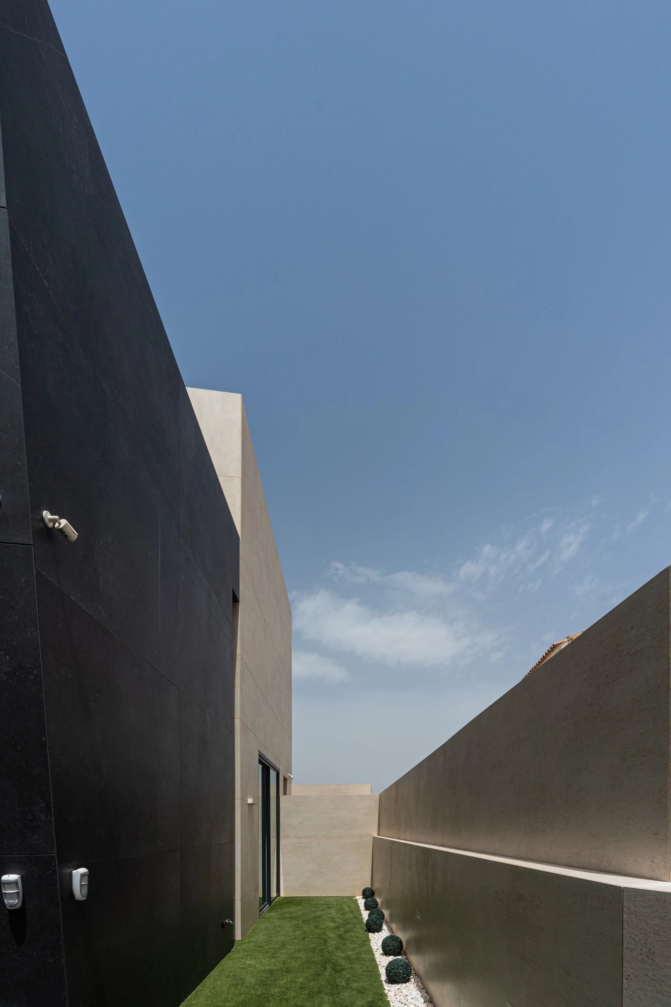 Dekton Fossil exterior wall cladding with smooth beige finish and clean lines — premium dekton surfaces fabricated and installed by Signature Stone LV