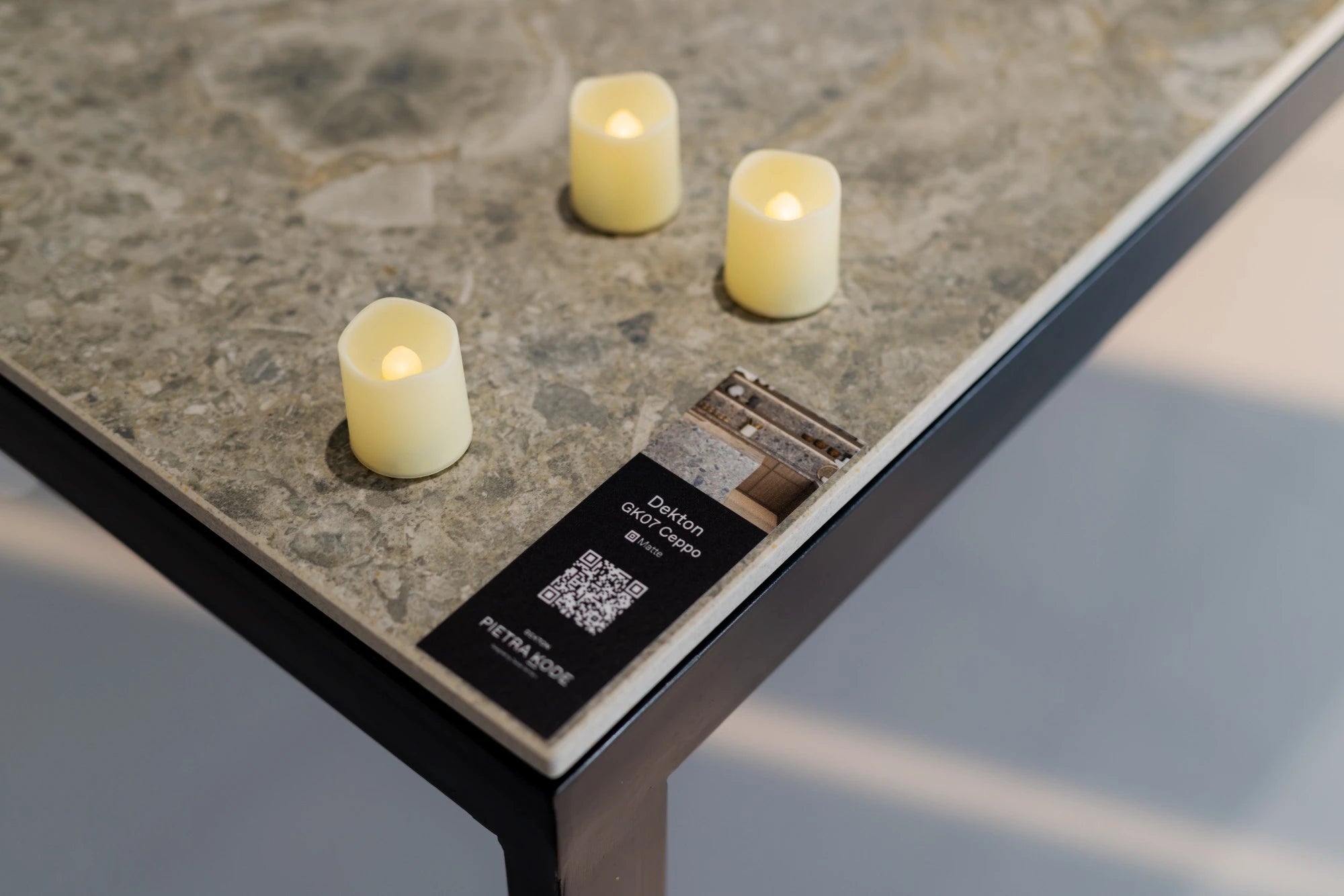 Dekton Gk07 Ceppo surface with natural stone texture and warm LED candles — dekton countertops installed by Signature Stone Las Vegas