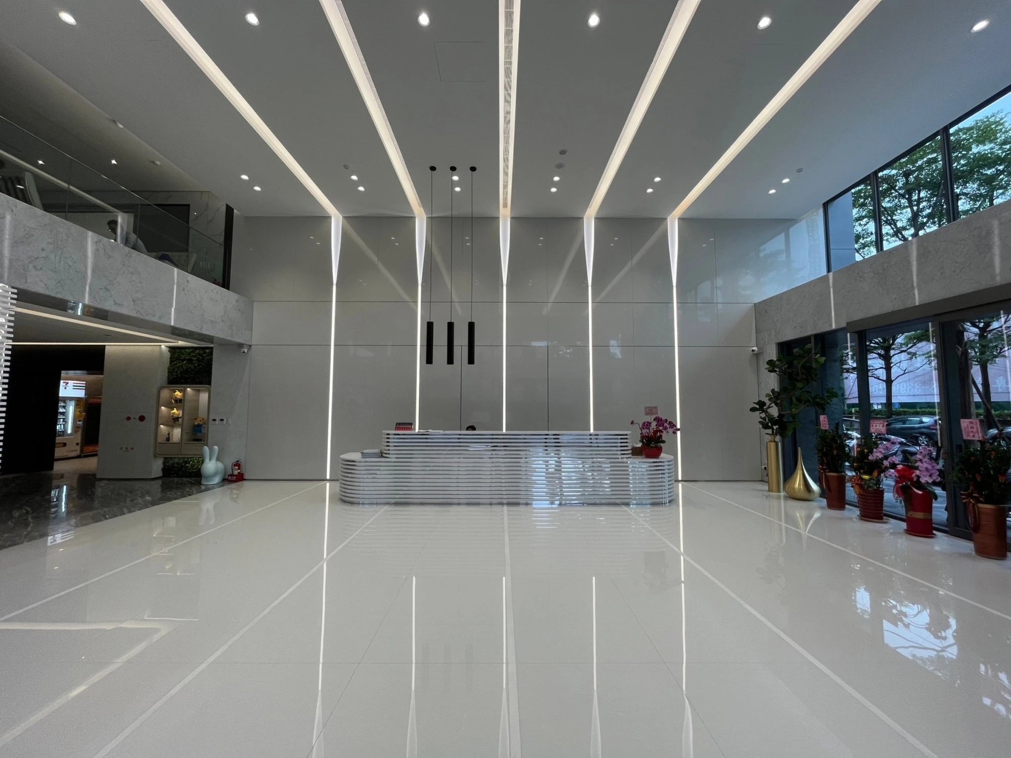 Dekton Halo flooring with polished white finish and linear LED ceiling design — premium dekton surfaces fabricated and installed by Signature Stone LV