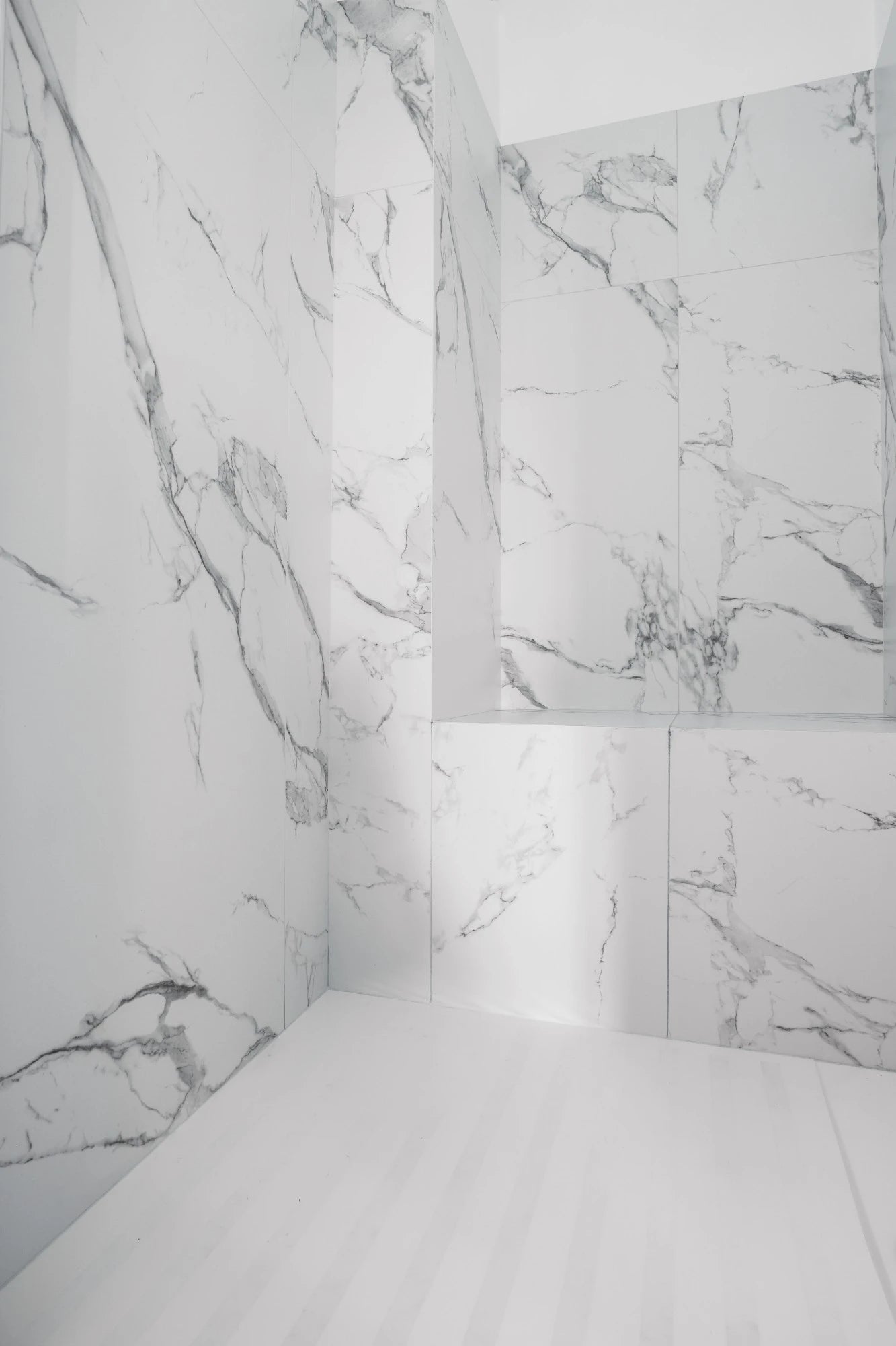 Silestone Iconic White quartz shower walls with dramatic gray veining and book-matched pattern — quartz countertops near me by Signature Stone Las Vegas