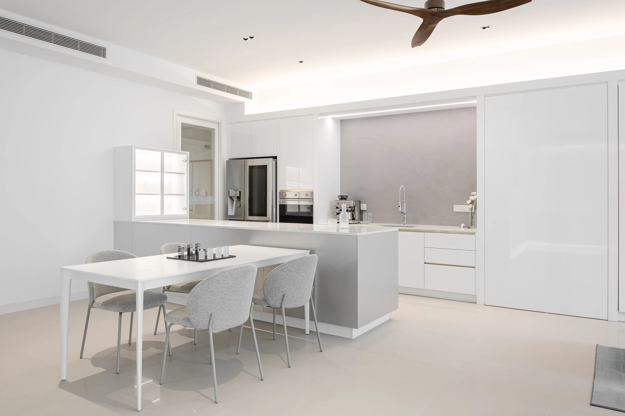 Silestone Iconic White kitchen island and perimeter surfaces with clean white finish and straight edges — quartz countertops installed by Signature Stone Las...