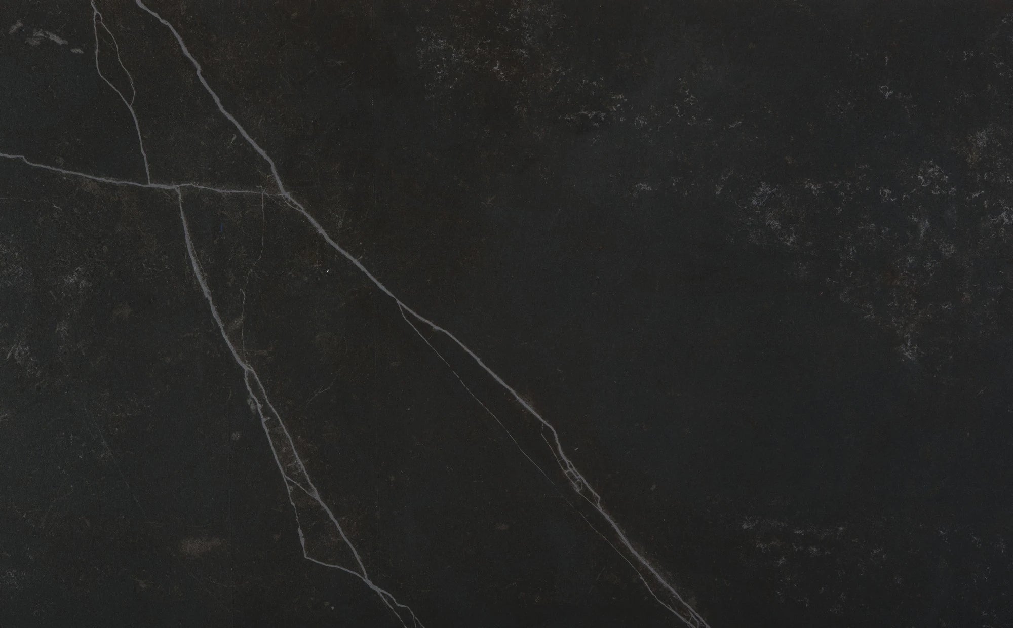 Dekton Kelya slab surface featuring dark charcoal base with dramatic white veining and matte finish — dekton countertops installed by Signature Stone Las Vegas