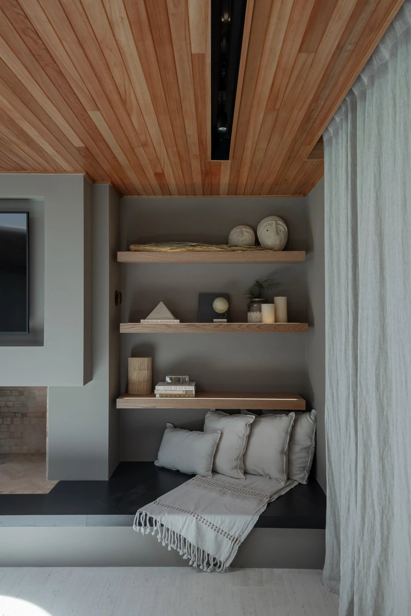 Dekton Kelya natural stone accent wall with gray veining in modern reading nook — dekton kitchen countertops by Signature Stone Las Vegas