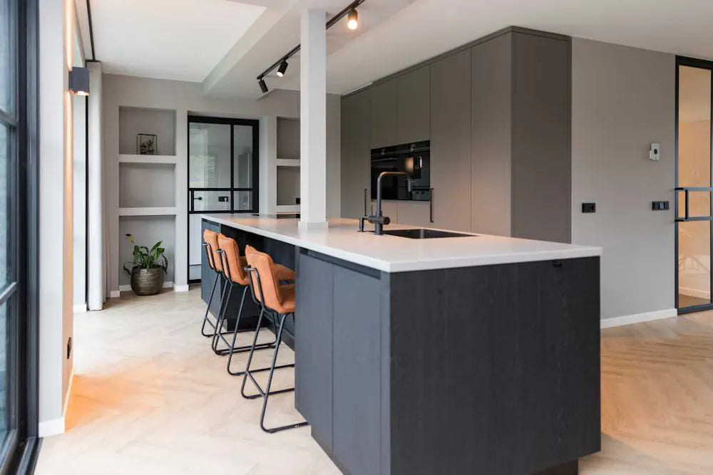 Silestone Kensho kitchen island with white surface and dark gray base in modern kitchen — engineered quartz countertops fabricated and installed by Signature...