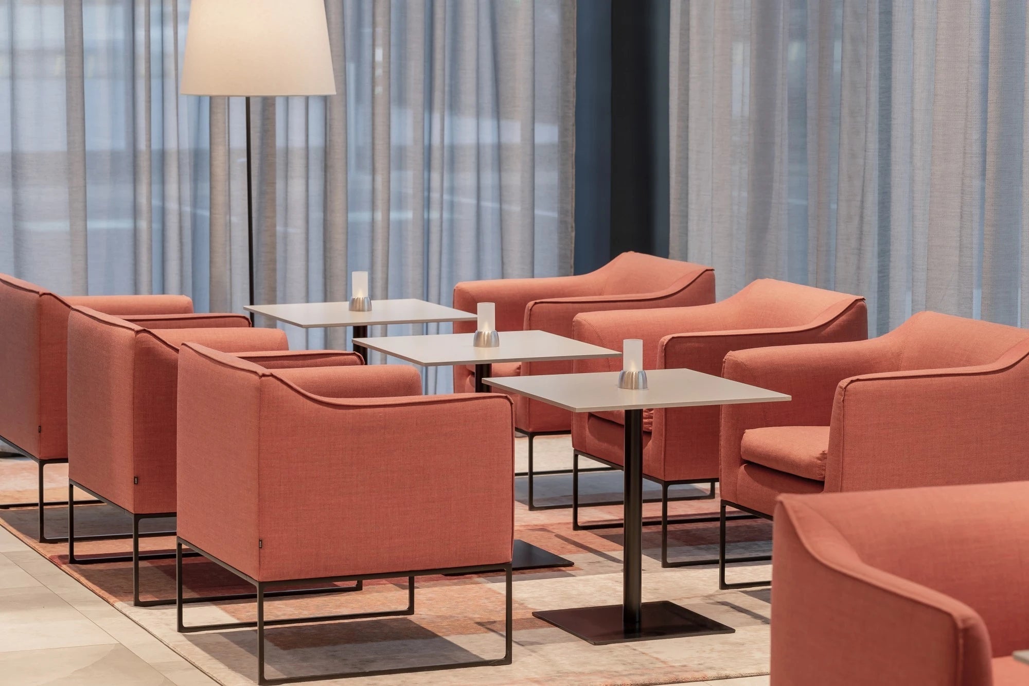 Silestone Kensho quartz surfaces in modern seating area with coral chairs and sleek tables — premium quartz countertops installed by Signature Stone Las Vegas
