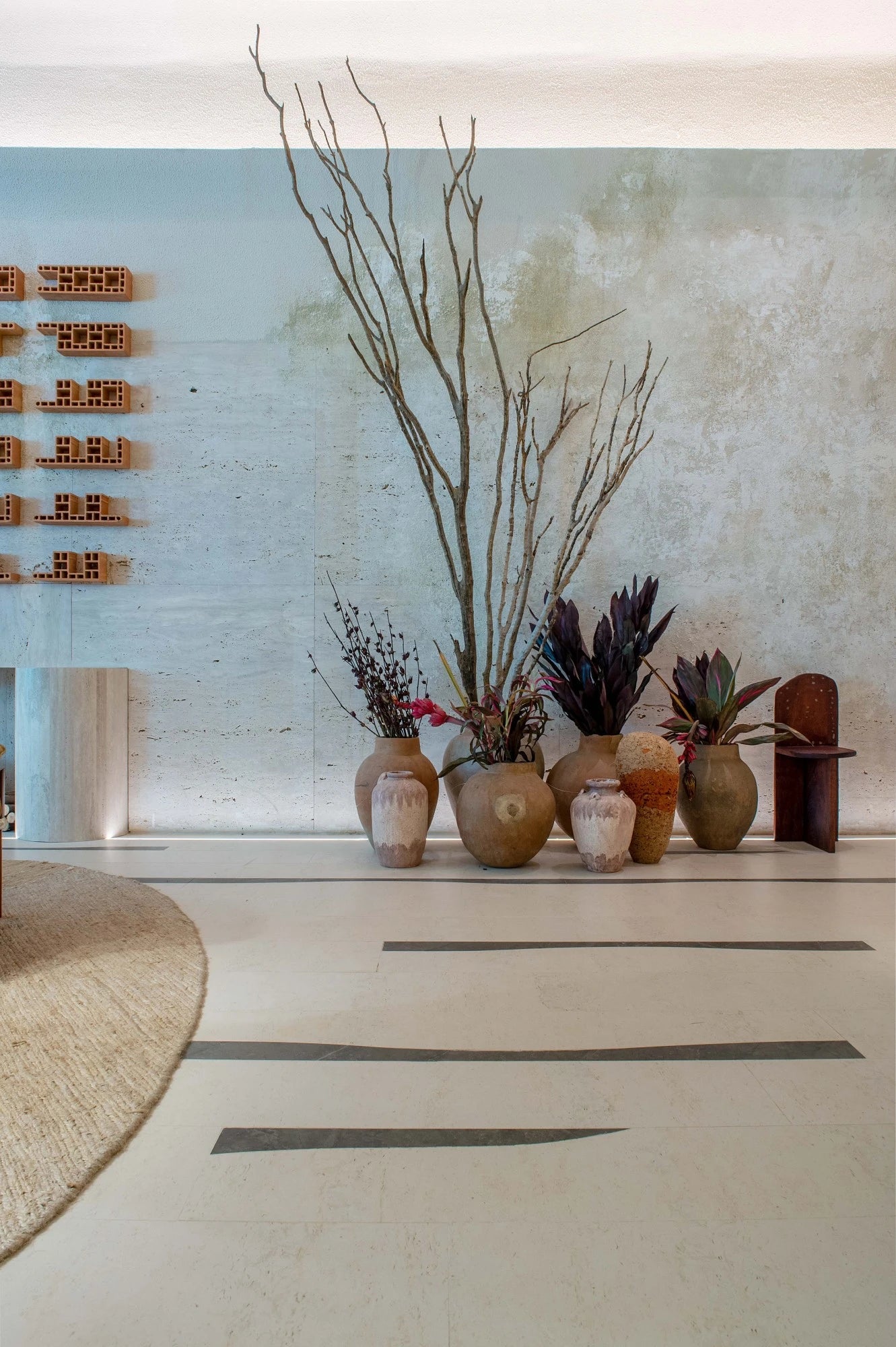 Dekton Kira flooring with light neutral tones and dark accent strips in modern interior — premium dekton surfaces fabricated and installed by Signature Stone LV