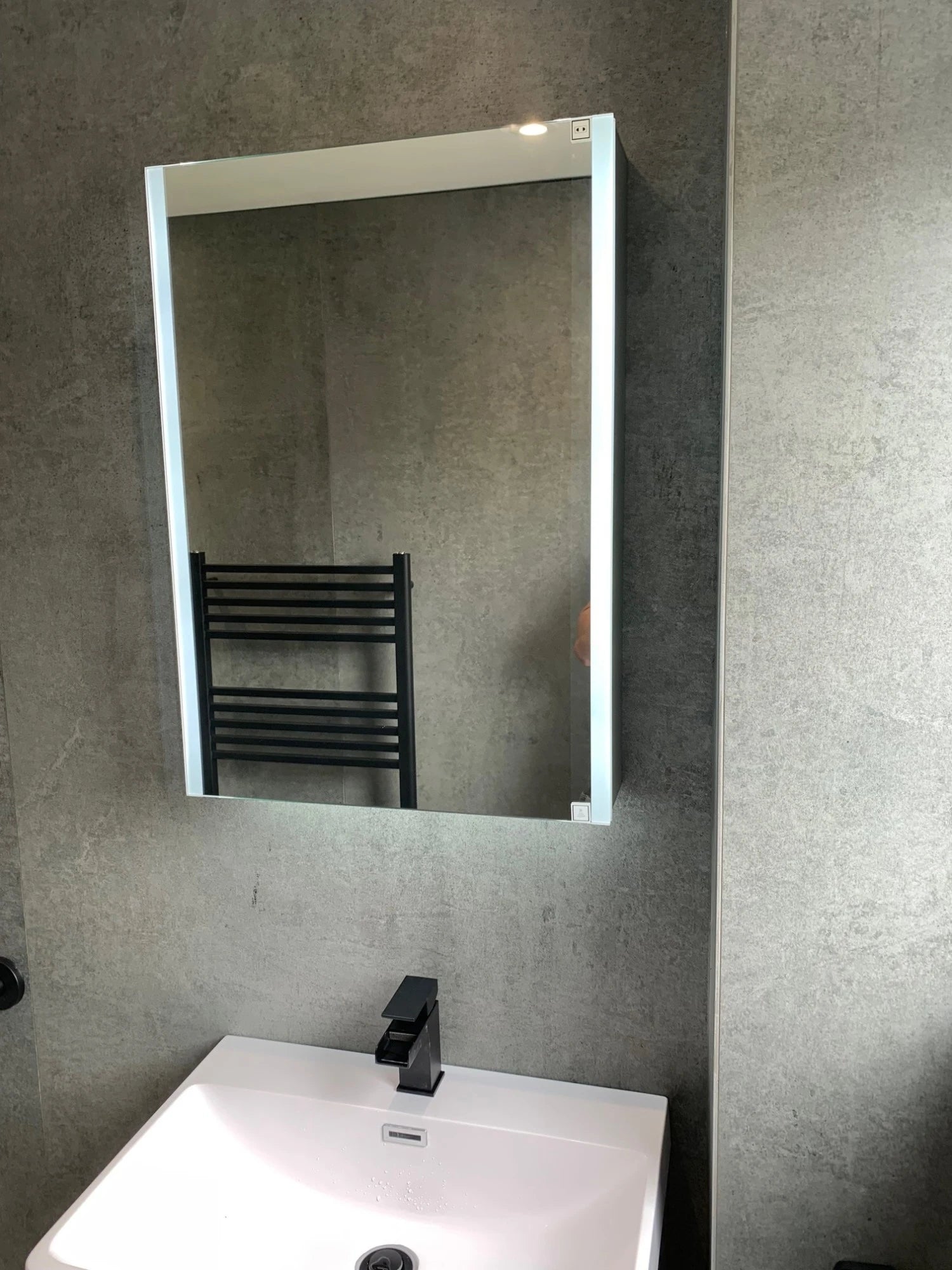 Dekton Kreta bathroom wall cladding with gray concrete-look finish — premium dekton surfaces fabricated and installed by Signature Stone LV