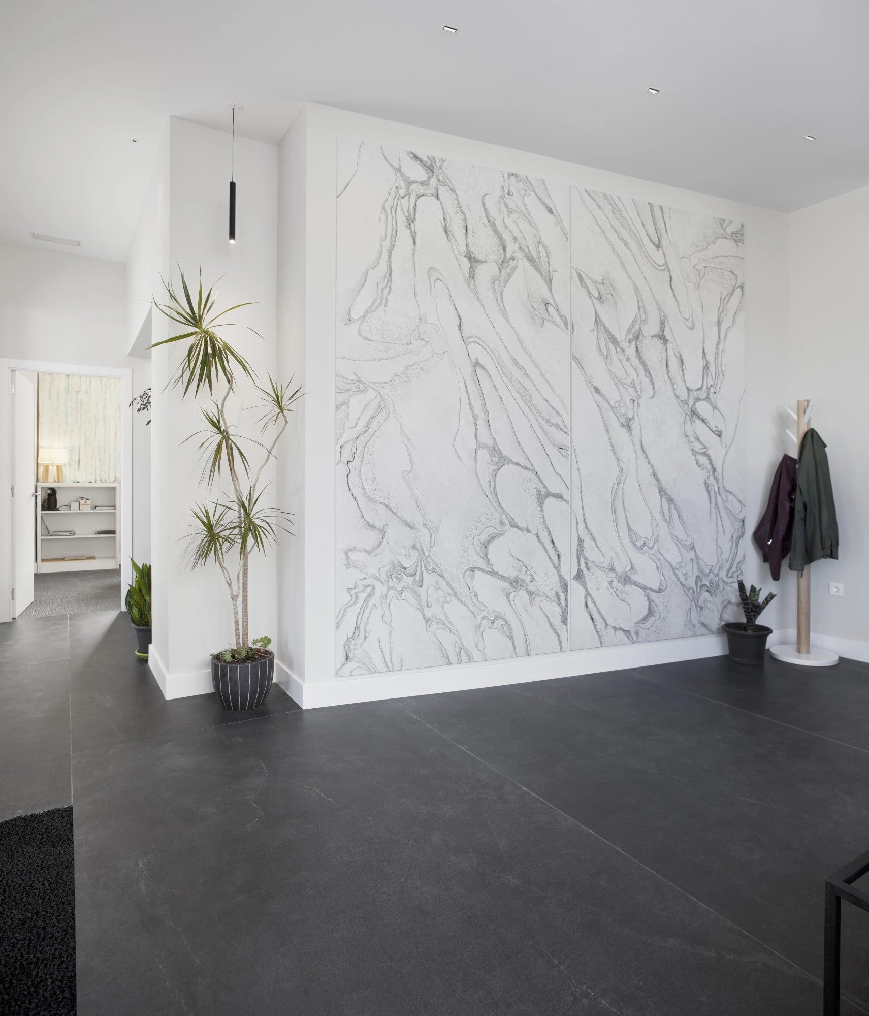 Dekton Laos feature wall with dramatic white marble veining in modern entryway — premium dekton countertops installed by Signature Stone Las Vegas