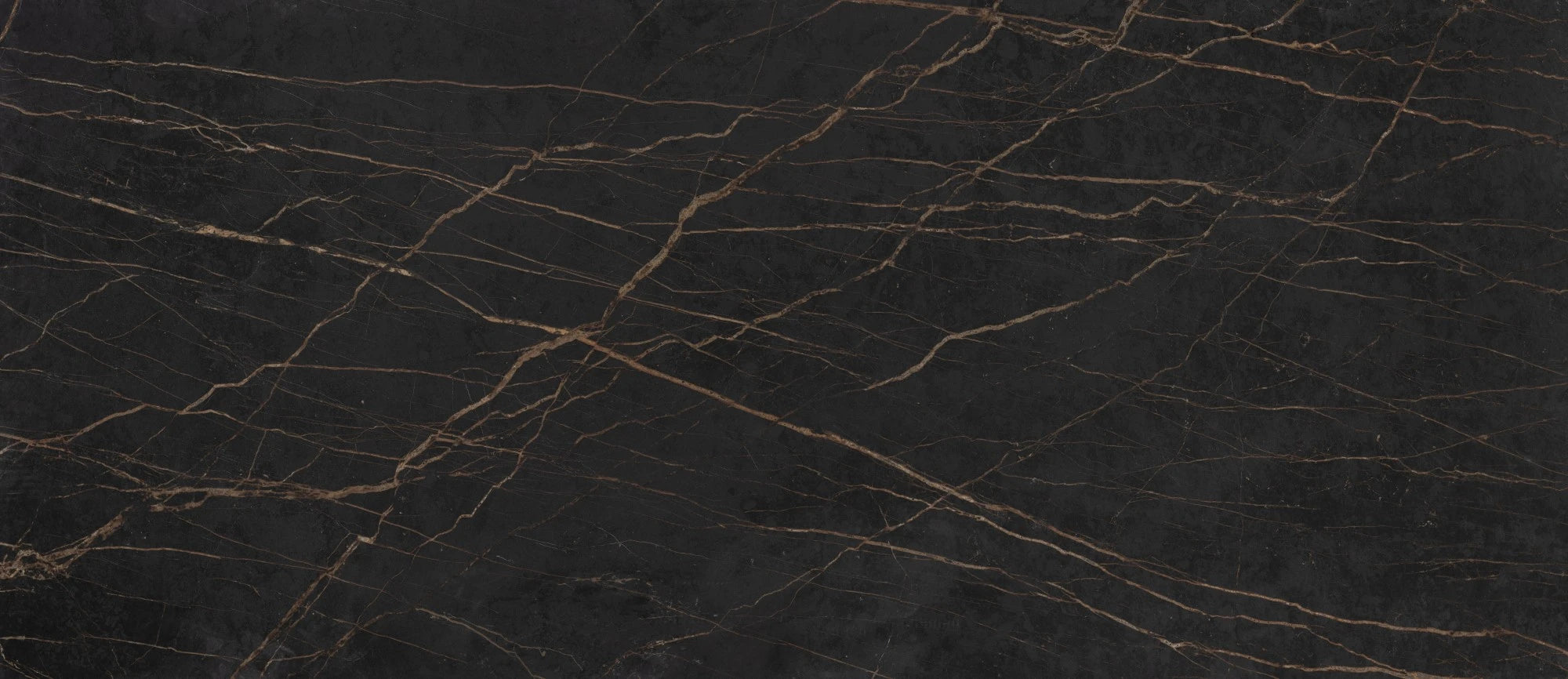 Dekton Laurent countertop surface with dark charcoal base and golden bronze veining — premium dekton surfaces fabricated and installed by Signature Stone LV