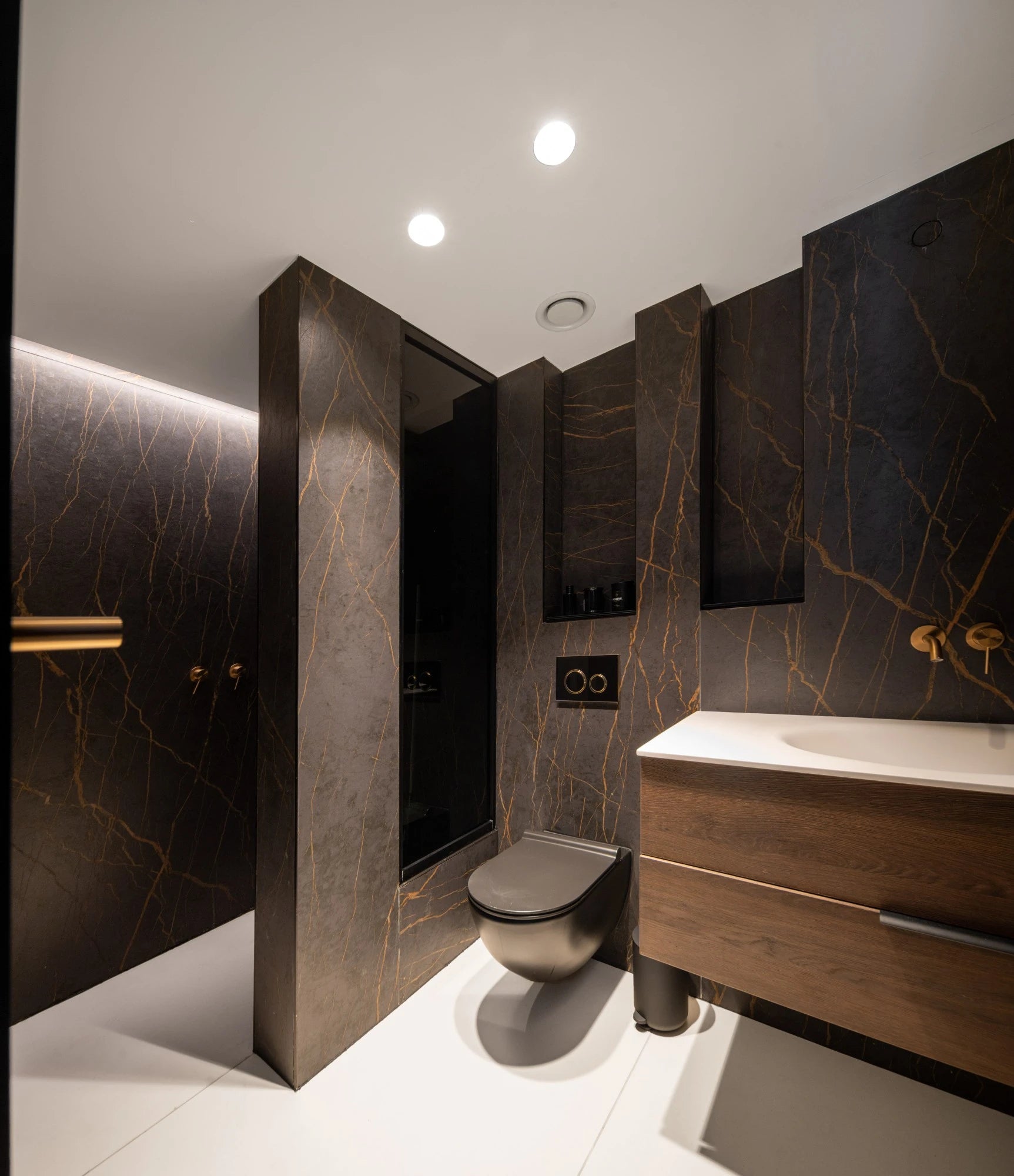 Dekton Laurent bathroom vanity with dark marble veining and gold accents — premium dekton surfaces fabricated and installed by Signature Stone LV