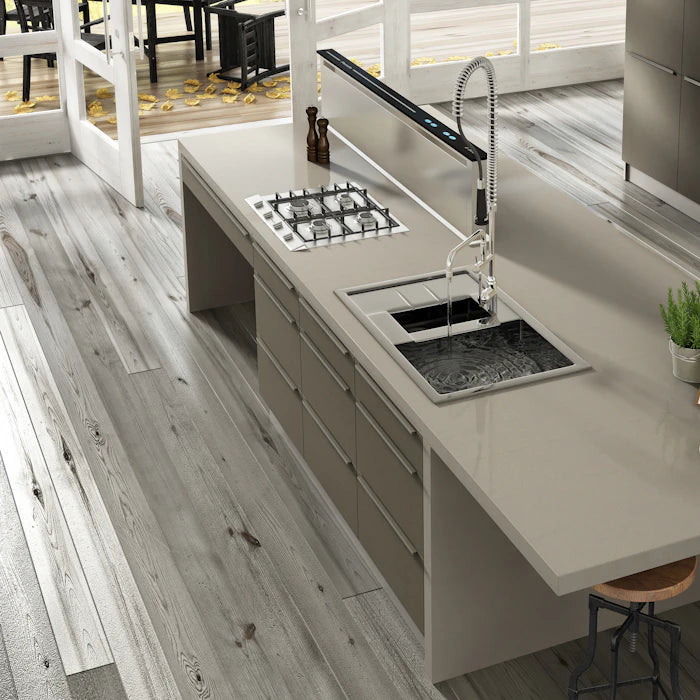 Silestone Lena Rougui kitchen island with light gray finish and integrated cooktop — engineered quartz countertops fabricated and installed by Signature Ston...