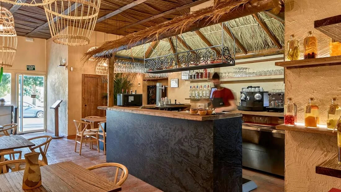 Dekton Liquid Embers countertop in modern cafe with dark volcanic pattern and wood accents — premium dekton surfaces fabricated and installed by Signature St...