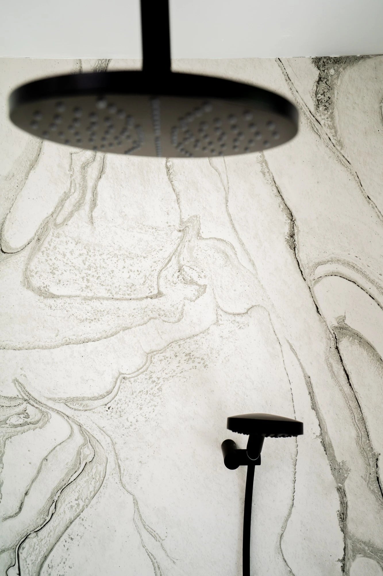 Dekton Liquid Sky shower surround with white marble veining and black rainfall showerhead — dekton kitchen countertops by Signature Stone Las Vegas
