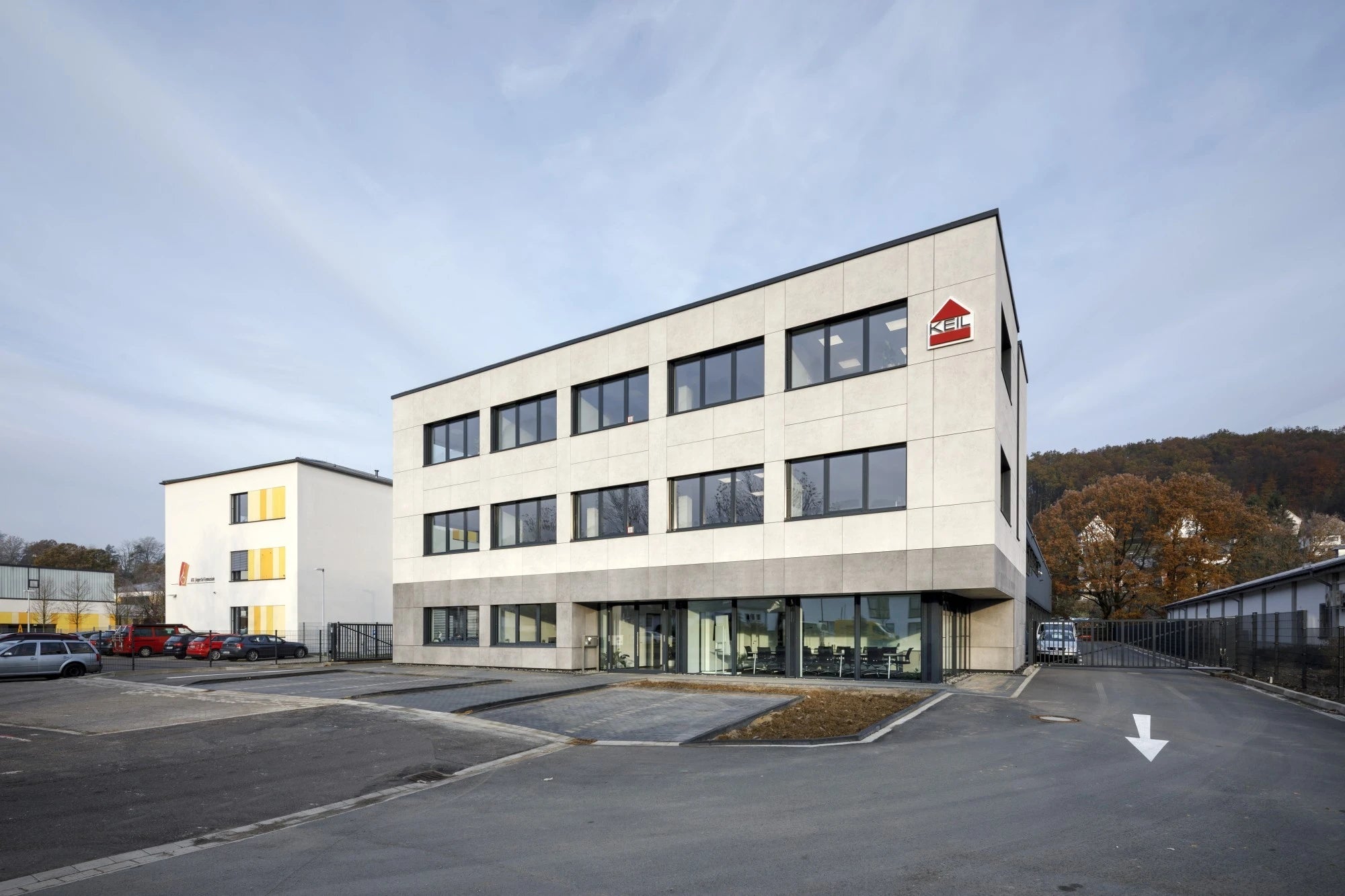 I can see this image shows a modern commercial building exterior, but I don't see any Dekton Lunar countertops, kitchen surfaces, or stone fabrication work v...