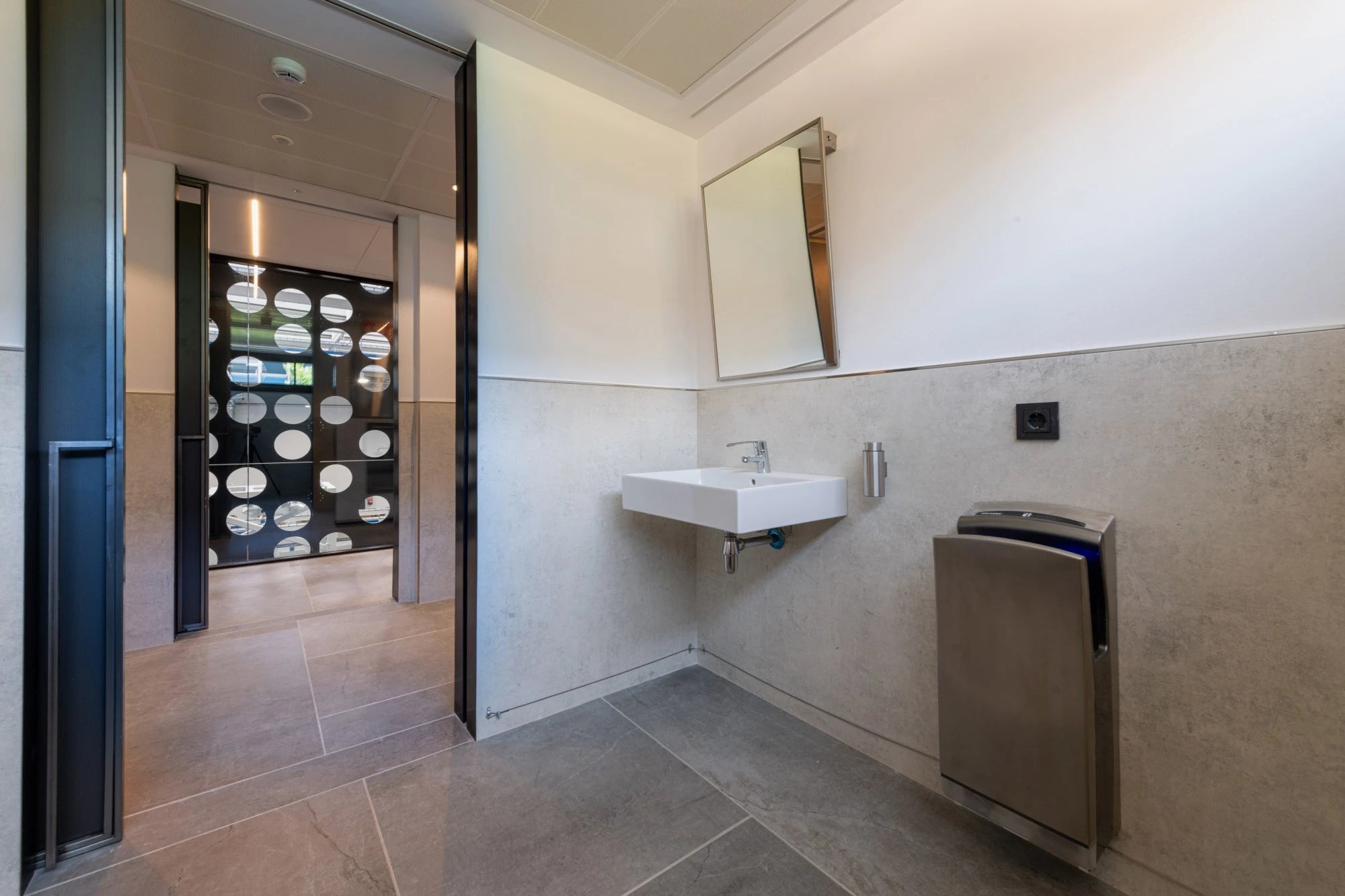 Dekton Lunar bathroom vanity with white rectangular vessel sink and modern wall-mounted design — premium dekton surfaces fabricated and installed by Signatur...