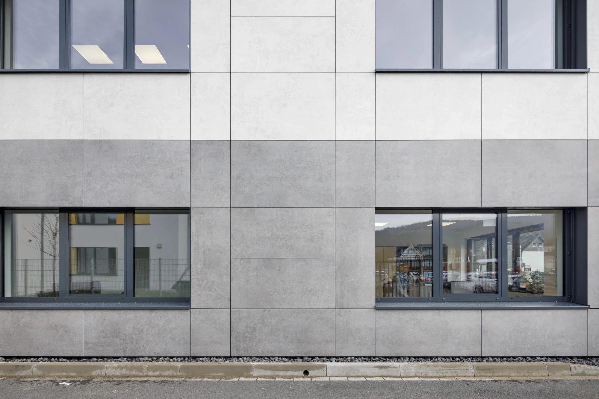 Dekton Lunar exterior cladding with light gray matte finish and clean panel joints — premium dekton surfaces fabricated and installed by Signature Stone LV