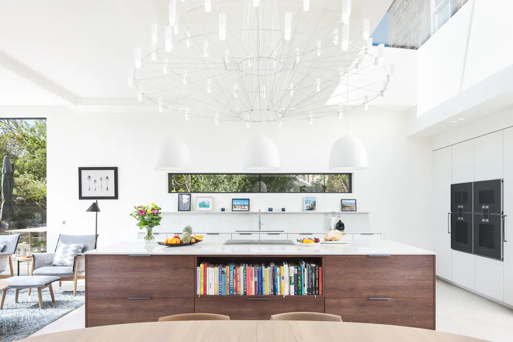Silestone Lusso kitchen island with white surface and walnut base featuring open book storage — engineered quartz countertops fabricated and installed by Sig...