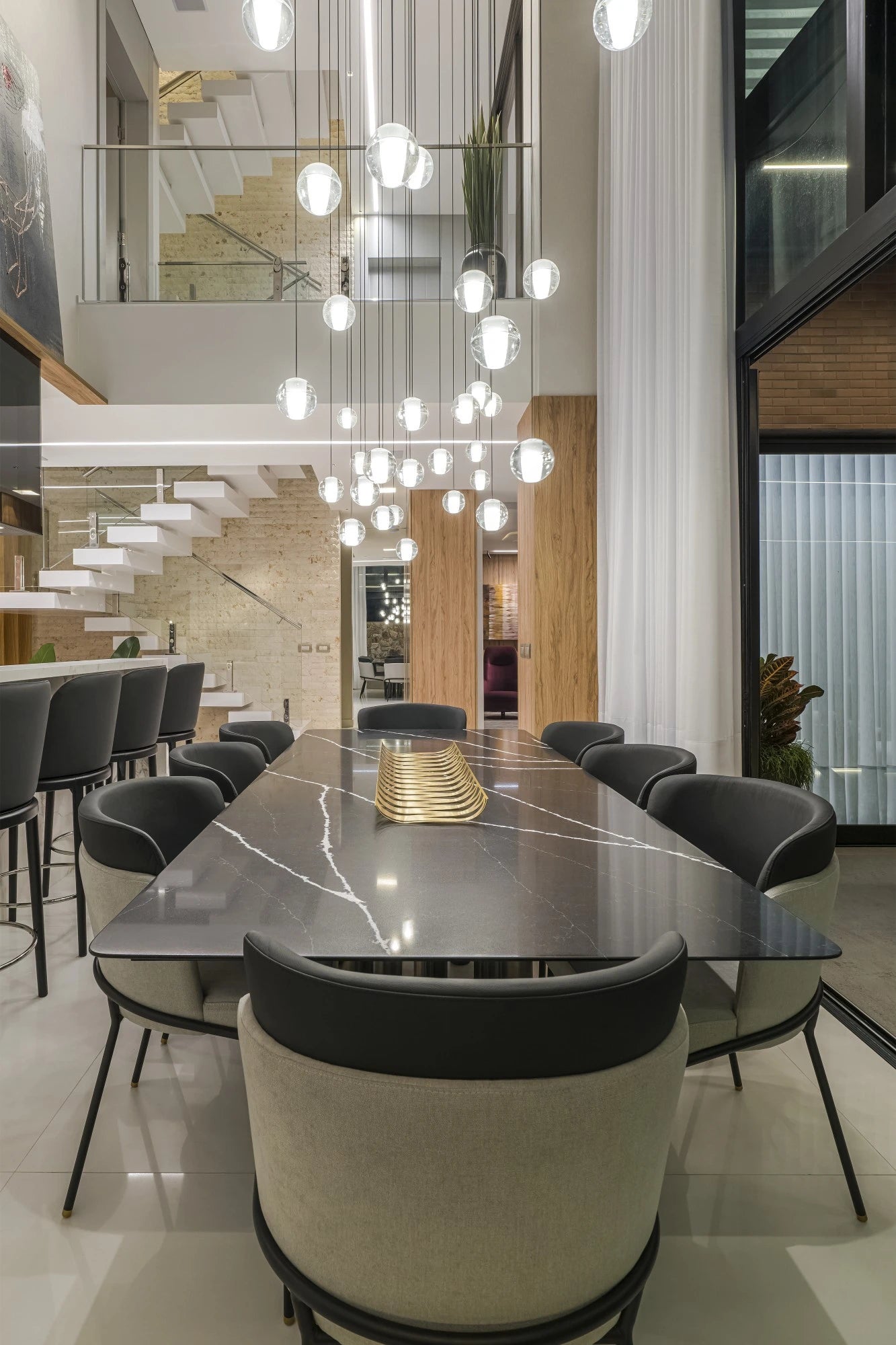 Silestone Miami White dining table with glossy black marble-look finish and gold centerpiece — engineered quartz countertops fabricated and installed by Sign...