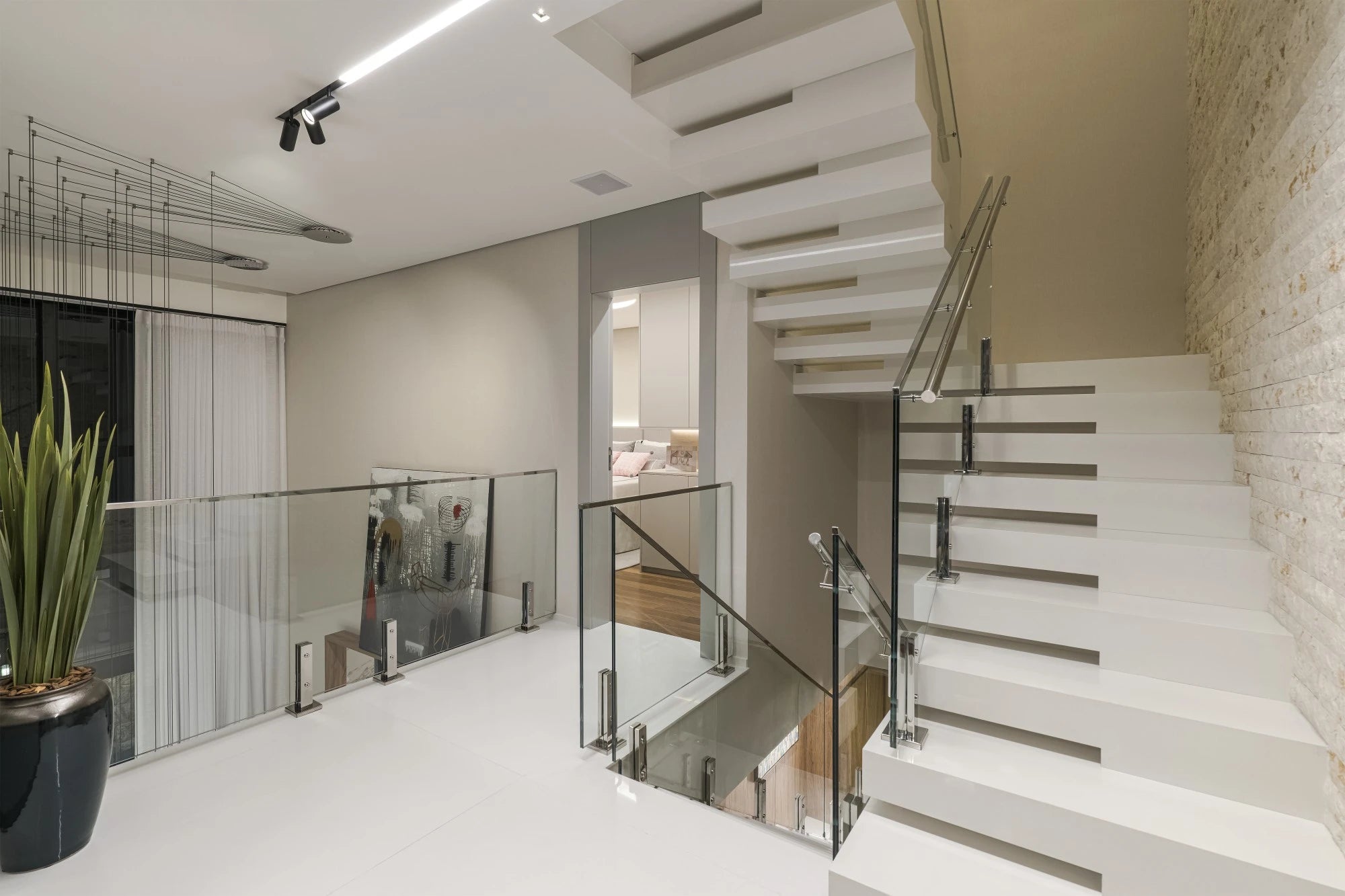 Silestone Miami White quartz staircase with sleek white finish and glass railings — premium quartz countertops near me by Signature Stone Las Vegas