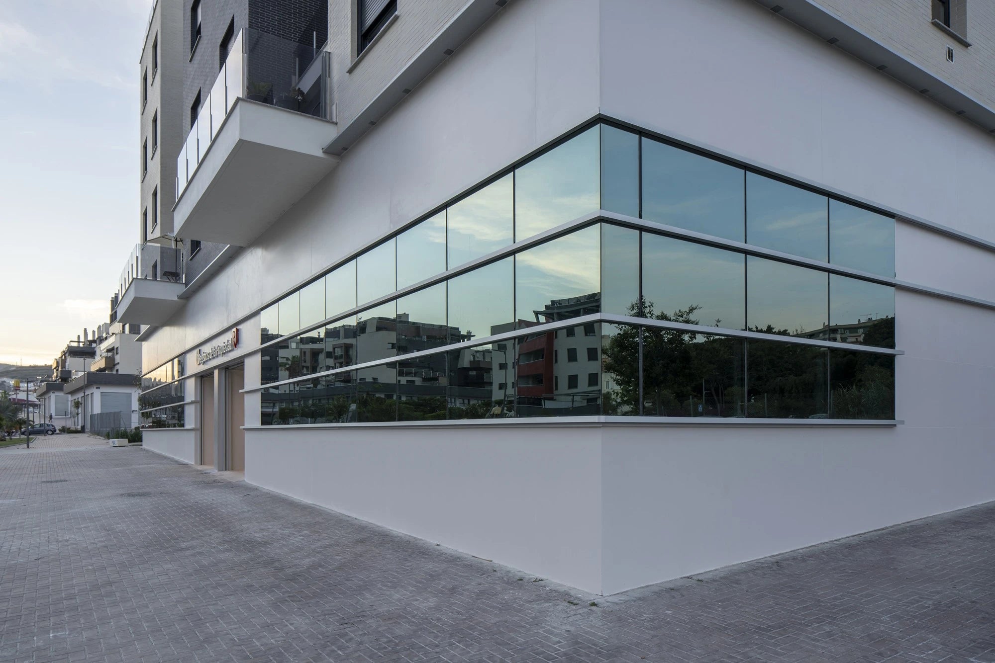 Dekton Moone surfaces on modern white building exterior with large glass windows — premium dekton kitchen countertops by Signature Stone Las Vegas